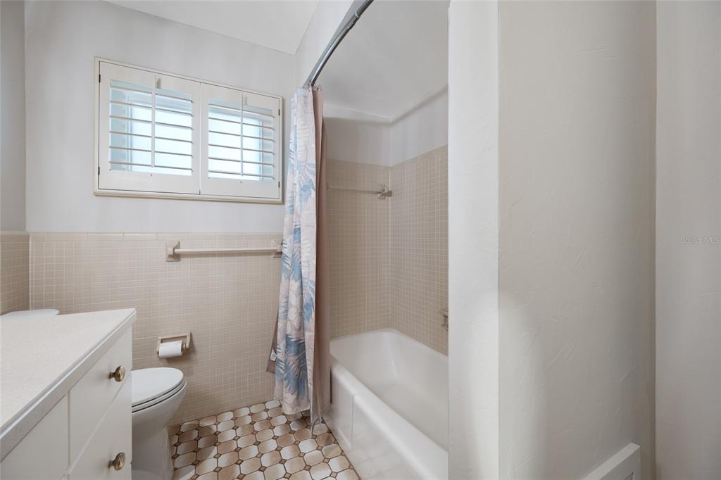 5473 97th Way North St. Petersburg, FL 33708 - Photo 33 of 57 a bathroom with a bathtub a toilet a sink and a shower