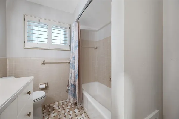 a bathroom with a bathtub a toilet a sink and a shower