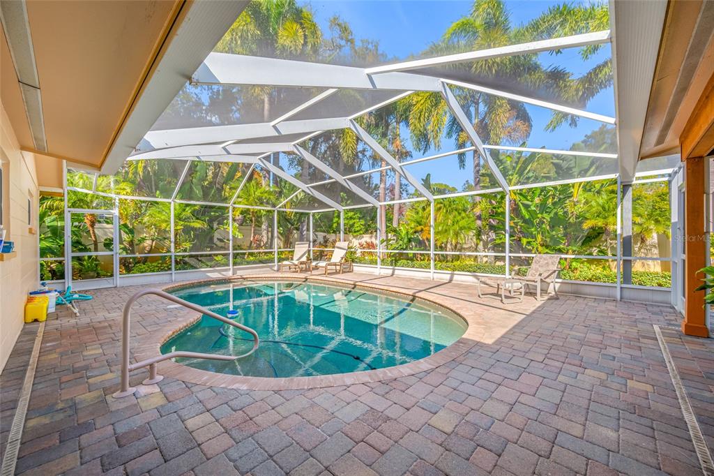 5473 97th Way North St. Petersburg, FL 33708 - Photo 46 of 62 a view of a swimming pool with a lounge chairs