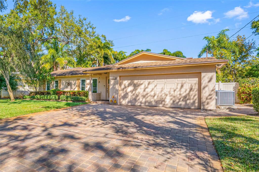 5473 97th Way North St. Petersburg, FL 33708 - Photo 7 of 57 a front view of a house with a yard and potted plants