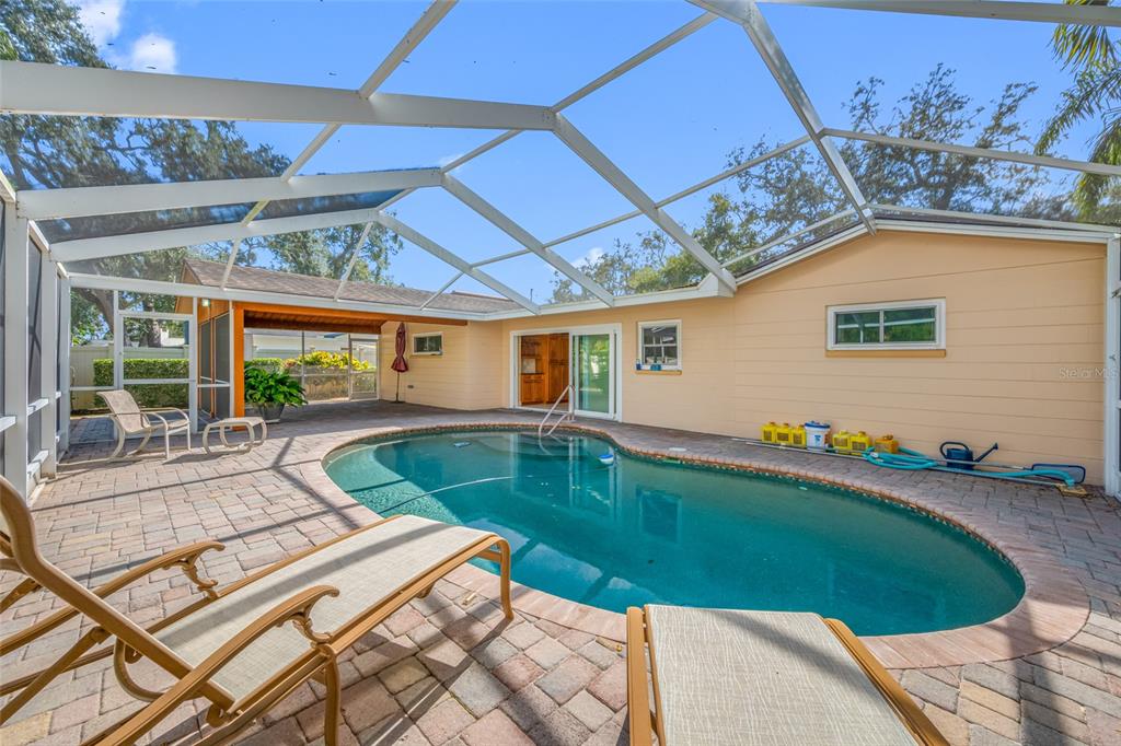 5473 97th Way North St. Petersburg, FL 33708 - Photo 8 of 57 a view of swimming pool with seating space