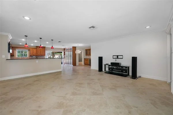 an empty room with furniture and a flat screen tv
