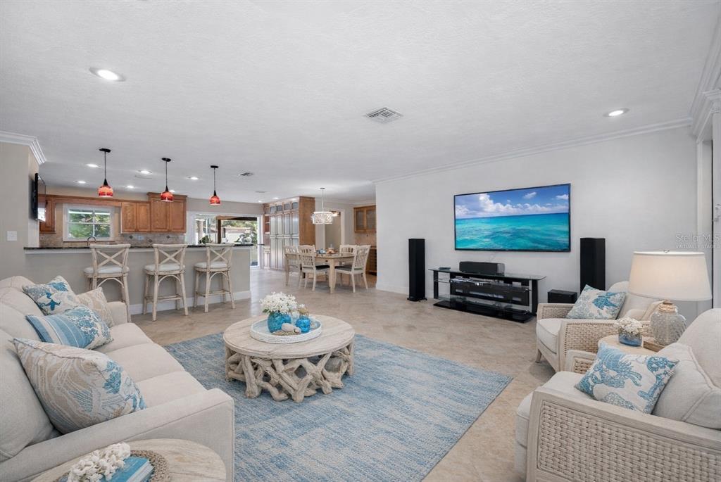 5473 97th Way North St. Petersburg, FL 33708 - Photo 10 of 62 a living room with furniture and a flat screen tv
