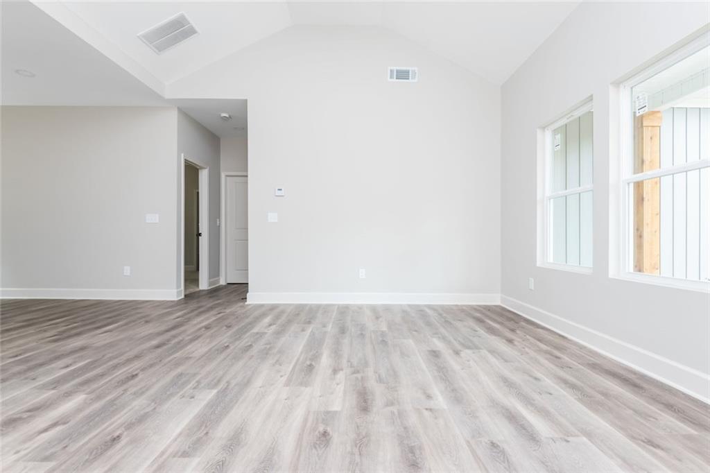 512 Branch Street Cedartown, GA 30125 - Photo 17 of 36 an empty room with wooden floor and windows