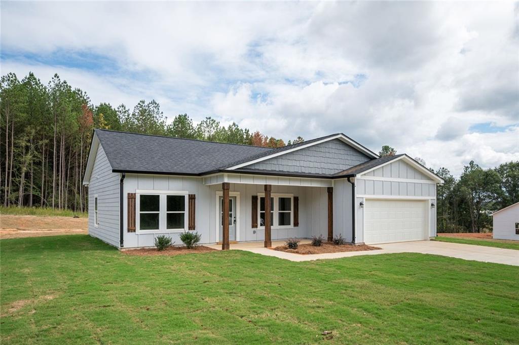 512 Branch Street Cedartown, GA 30125 - Photo 5 of 36 a front view of a house with a garden and yard