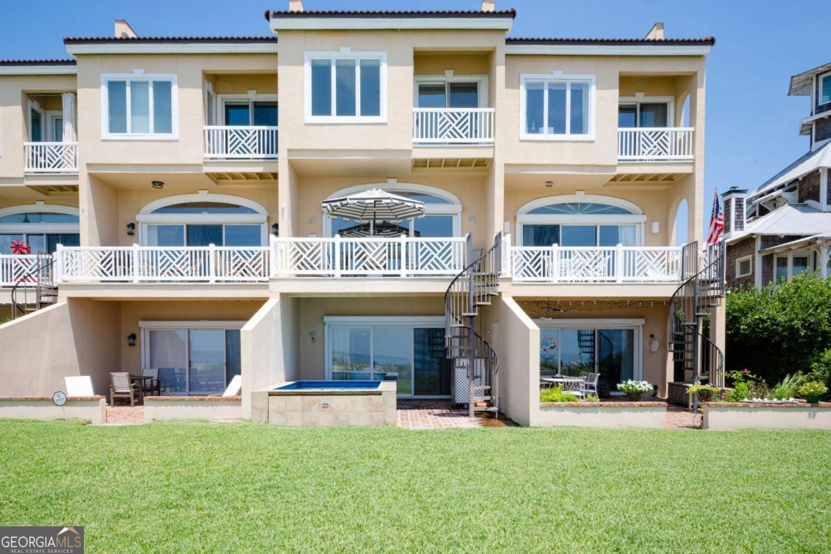 1028 Beach View Drive, Unit 2 St. Simons, GA 31522 - Photo 1 of 1 a front view of a brick building with a yard