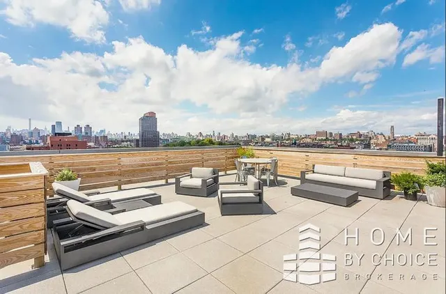 a view of a terrace with lawn chairs