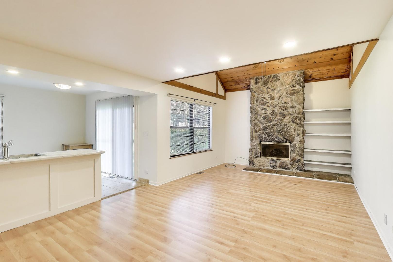 691 Wakefield Road, Unit 691 Gurnee, IL 60031 - Photo 6 of 26 a view of an empty room with window and wooden floor