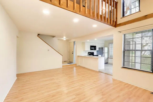 a view of an entryway with kitchen and windows