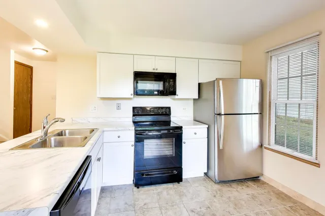 a kitchen with stainless steel appliances a refrigerator stove and sink