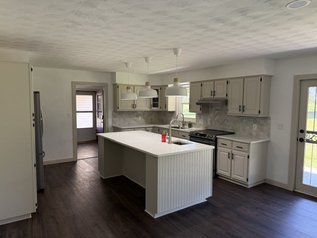 6241 Wards Mill Road Marion, IL 62959 - Photo 3 of 29 a kitchen with kitchen island wooden floors white cabinets and stainless steel appliances