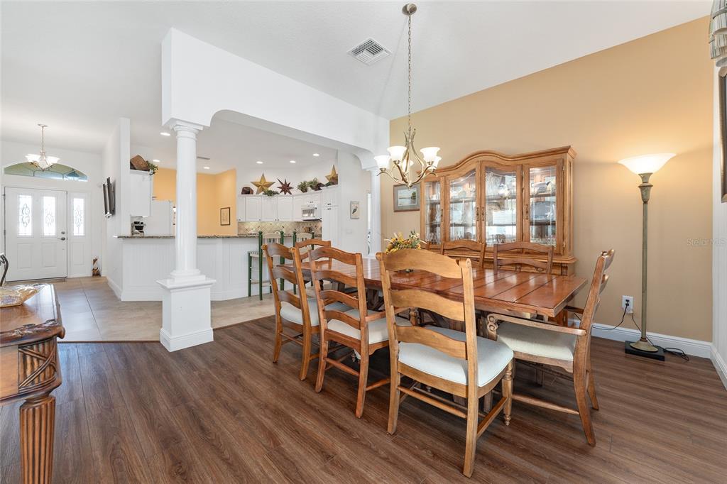 2053 Beecher Path The Villages, FL 32162 - Photo 14 of 44 a view of a dining room with furniture window and wooden floor