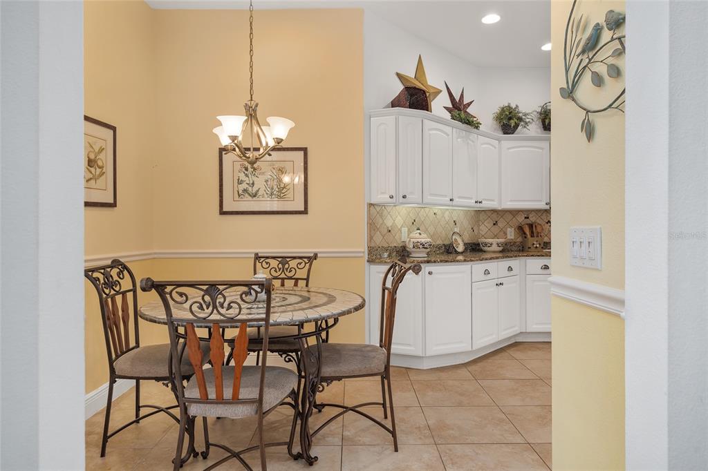 2053 Beecher Path The Villages, FL 32162 - Photo 9 of 44 a view of a dining room with furniture and a chandelier