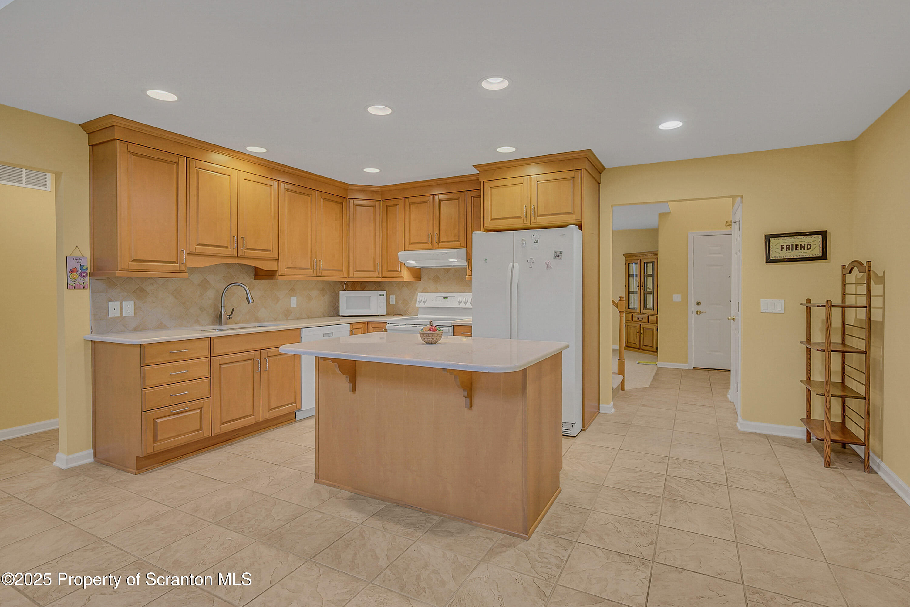 83 Hedge Row Run Clarks Summit, PA 18411 - Photo 13 of 49 a kitchen with kitchen island cabinets and refrigerator