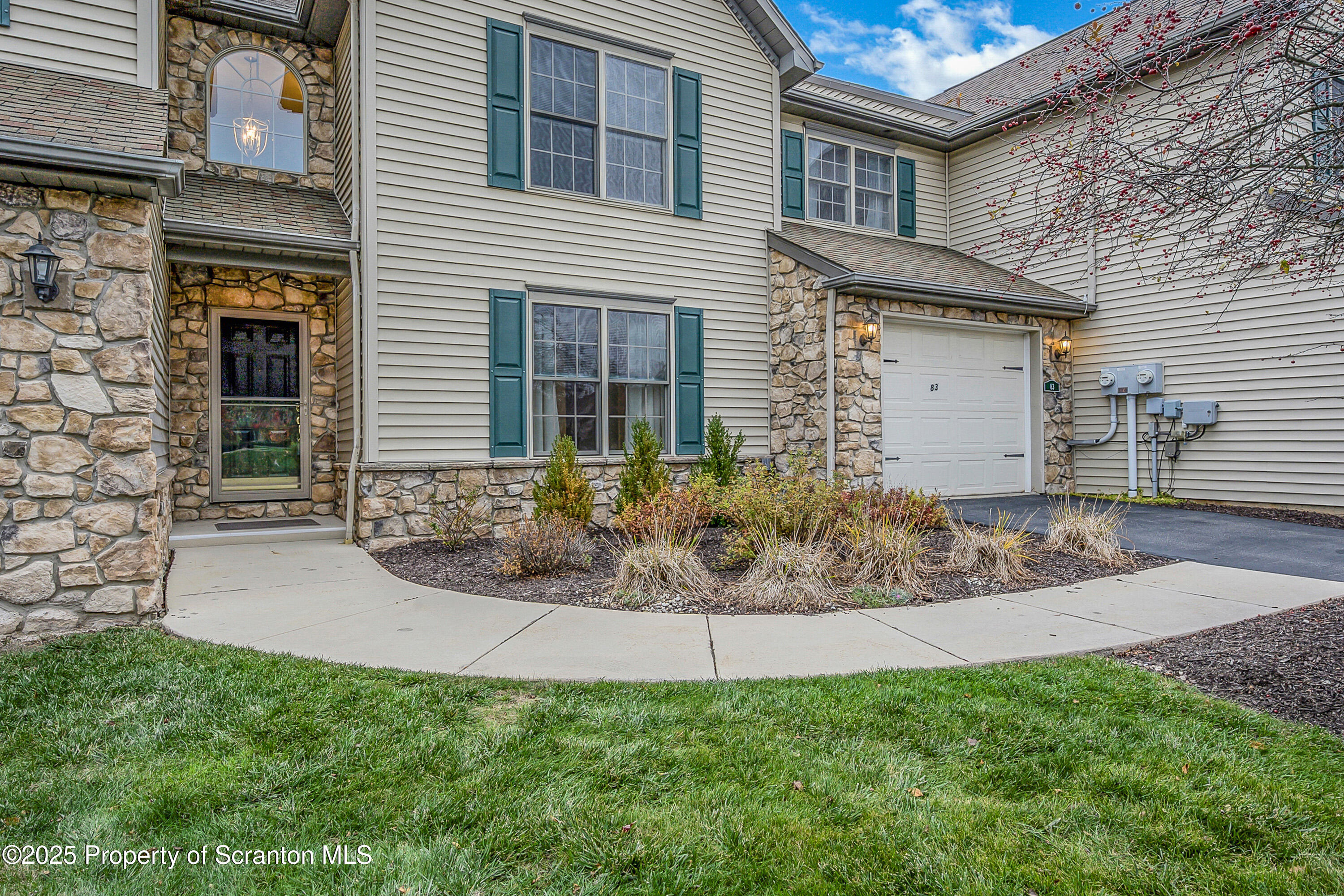 83 Hedge Row Run Clarks Summit, PA 18411 - Photo 2 of 49 a view of a house with brick walls plants and large tree