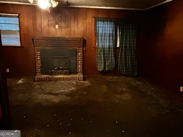 a view of an empty room with a fireplace