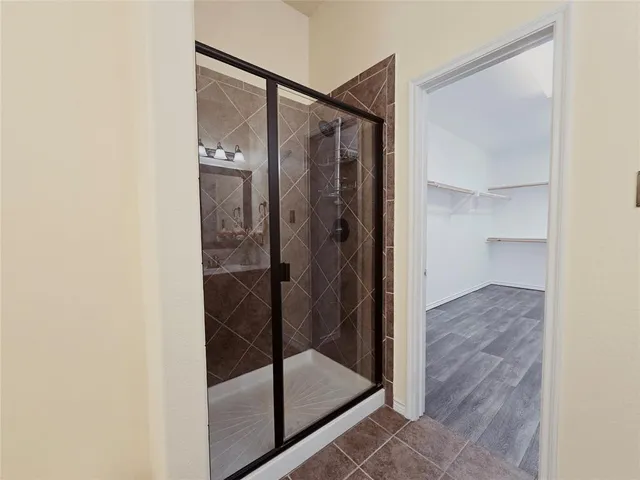 a bathroom with a glass shower door