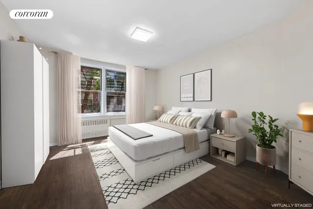 a bedroom with a bed and a large window