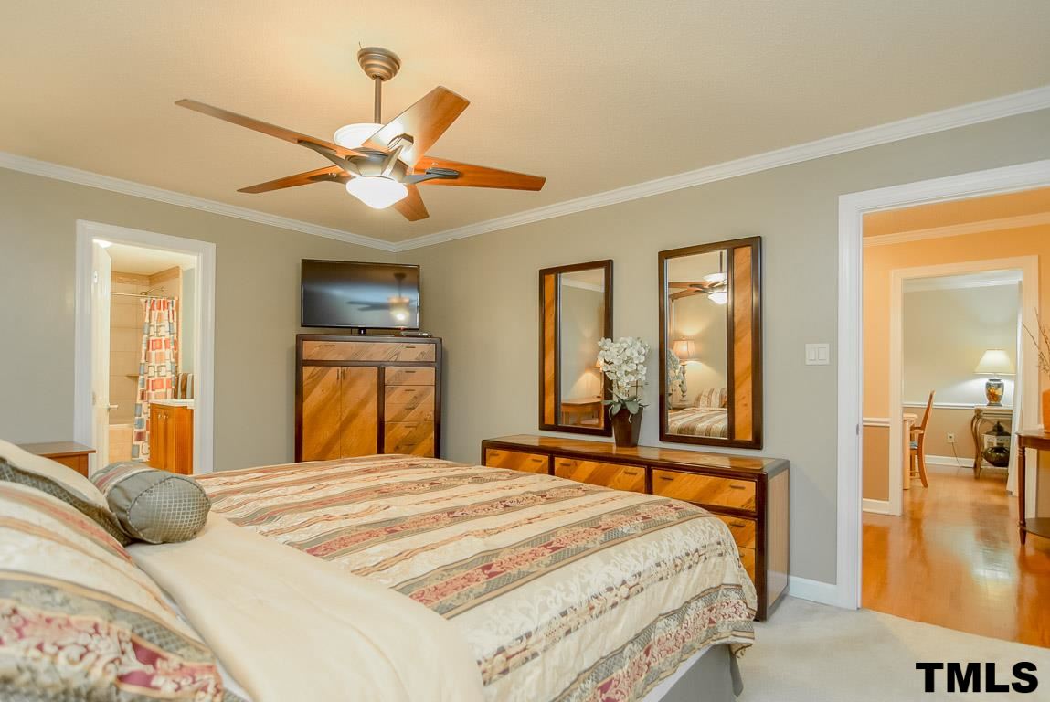 8101 Winstone Court Raleigh, NC 27615 - Photo 12 of 25 Master features neutral decor, crown molding and ceiling fan.