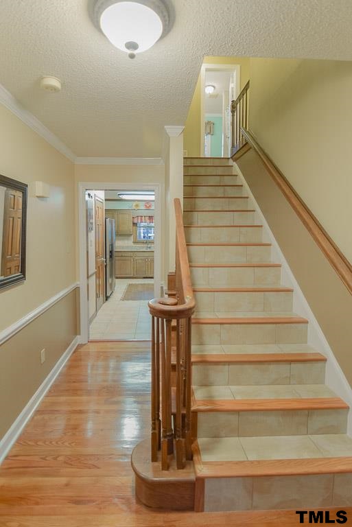 8101 Winstone Court Raleigh, NC 27615 - Photo 3 of 25 Inviting foyer with hardwood floors and chair-rail
