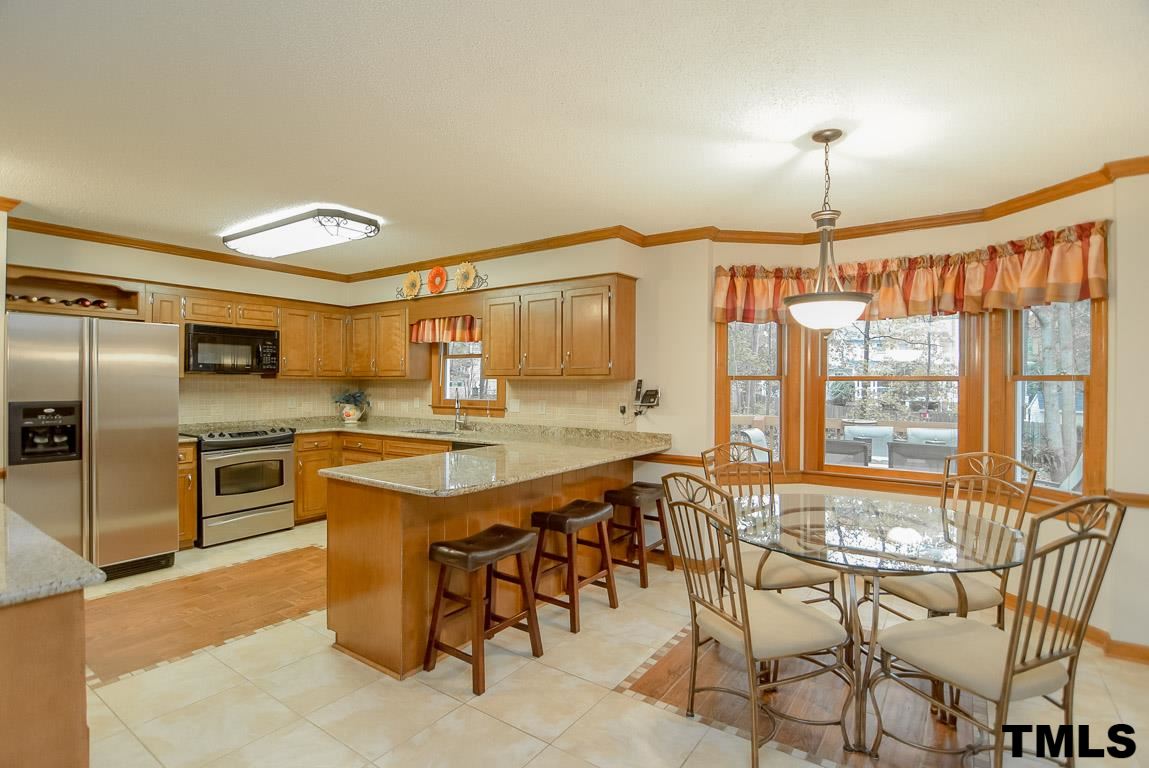 8101 Winstone Court Raleigh, NC 27615 - Photo 4 of 25 Open kitchen with ample cabinet space, designer tile floor with inlays.