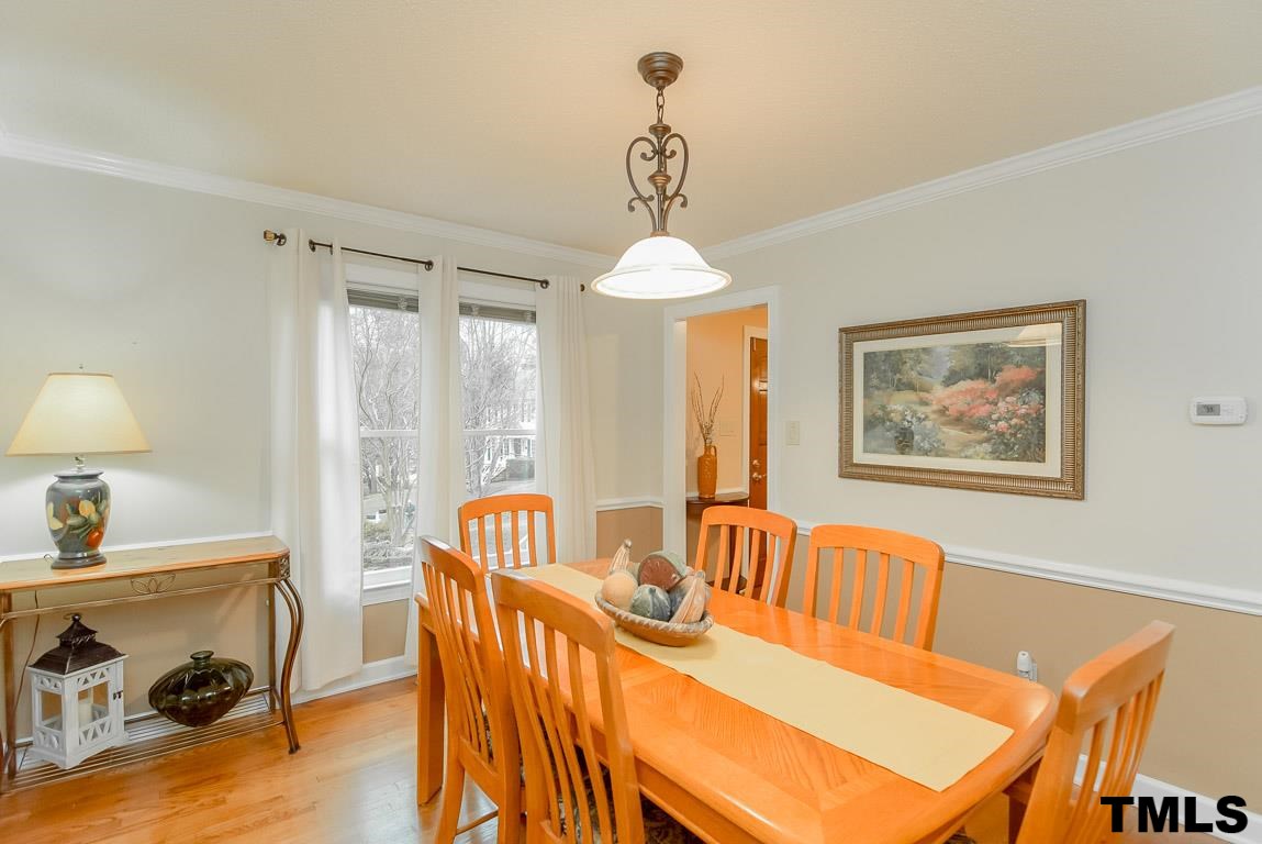 8101 Winstone Court Raleigh, NC 27615 - Photo 9 of 25 Formal dining room features crown molding, hardwood floors, chair rail and floor to ceiling windows.