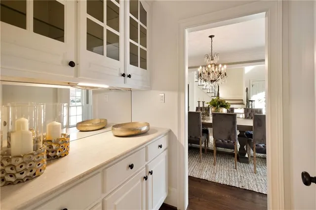 a living room with furniture a fireplace and a floor to ceiling window