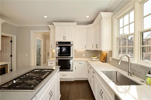 a large living room with furniture a fireplace and a window