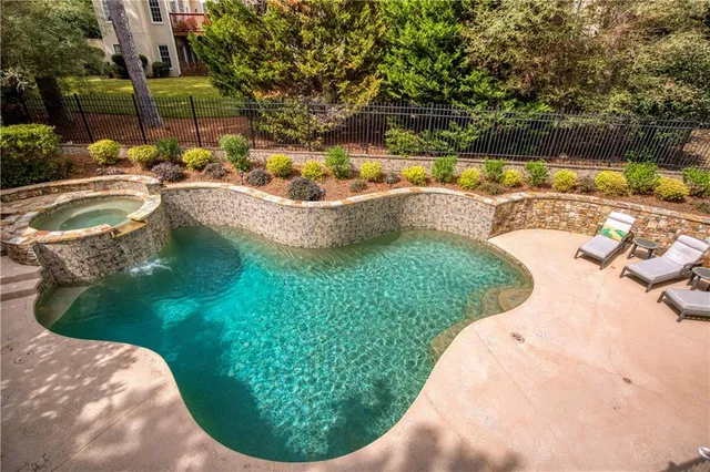 a view of a swimming pool in a backyard