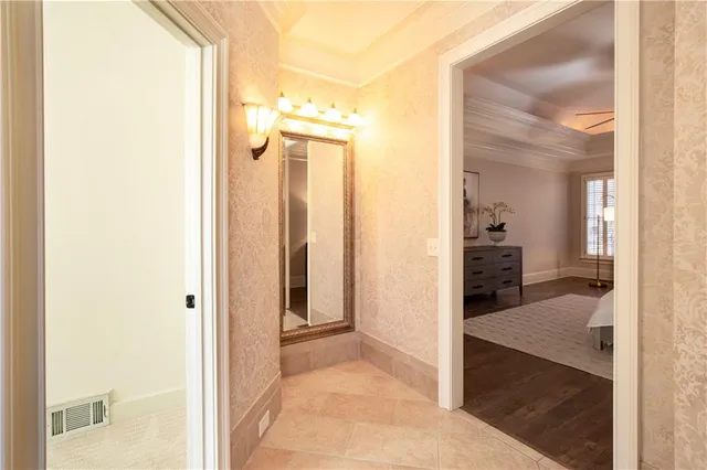 a view of bathroom with a sink a potted plant and a mirror