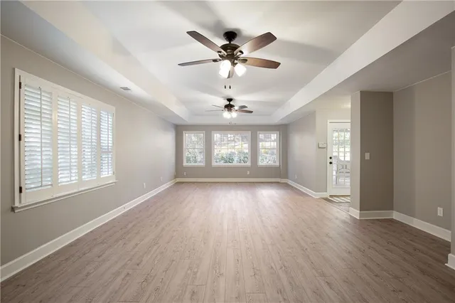 an aerial view of a house with swimming pool and large trees