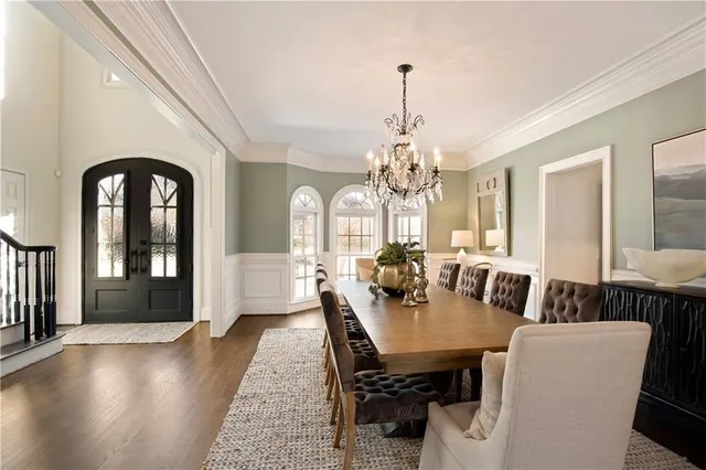 a living room with furniture a chandelier and a fireplace