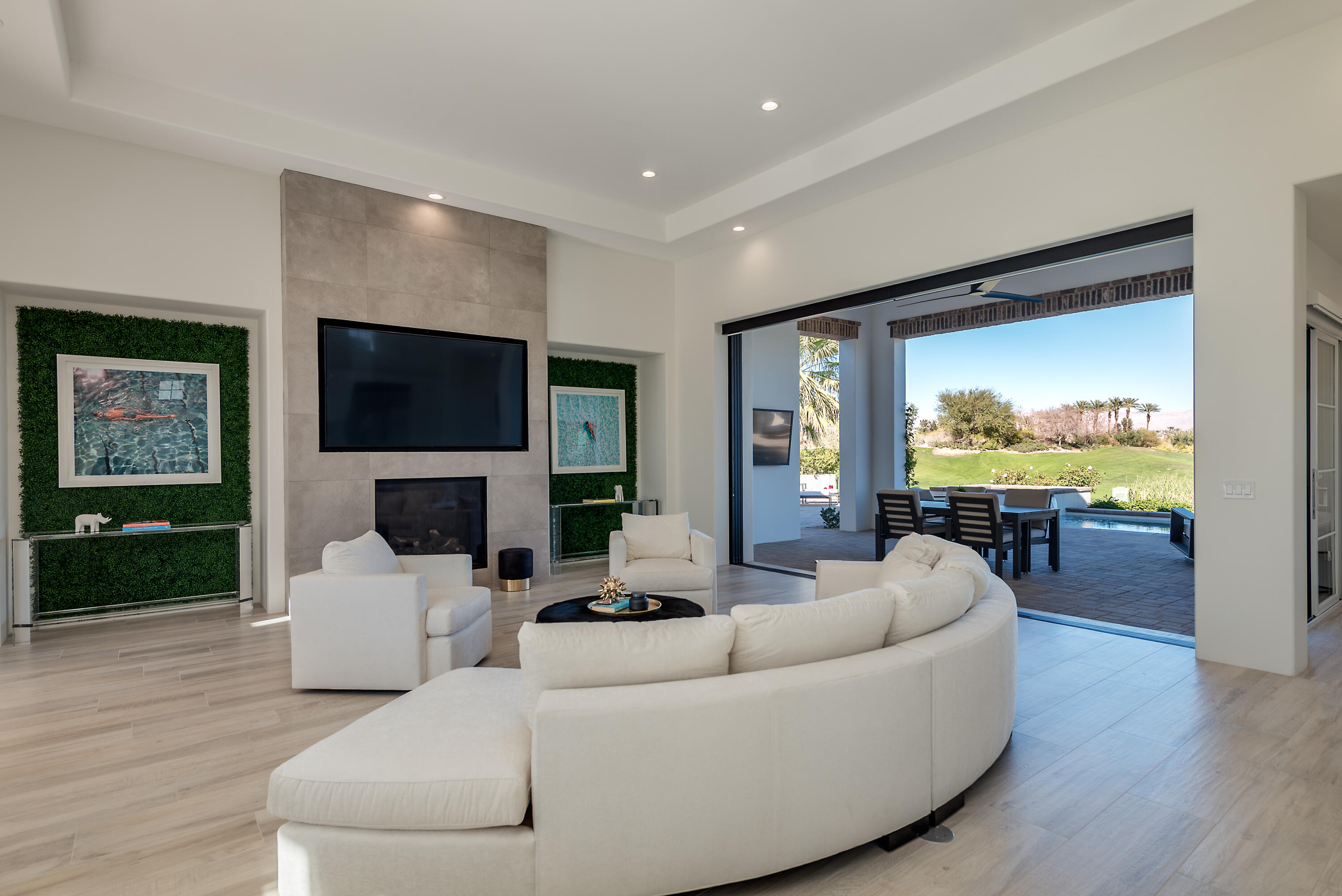 81660 Andalusia La Quinta, CA 92253 - Photo 12 of 36 a living room with furniture floor to ceiling window wooden floor and a flat screen tv