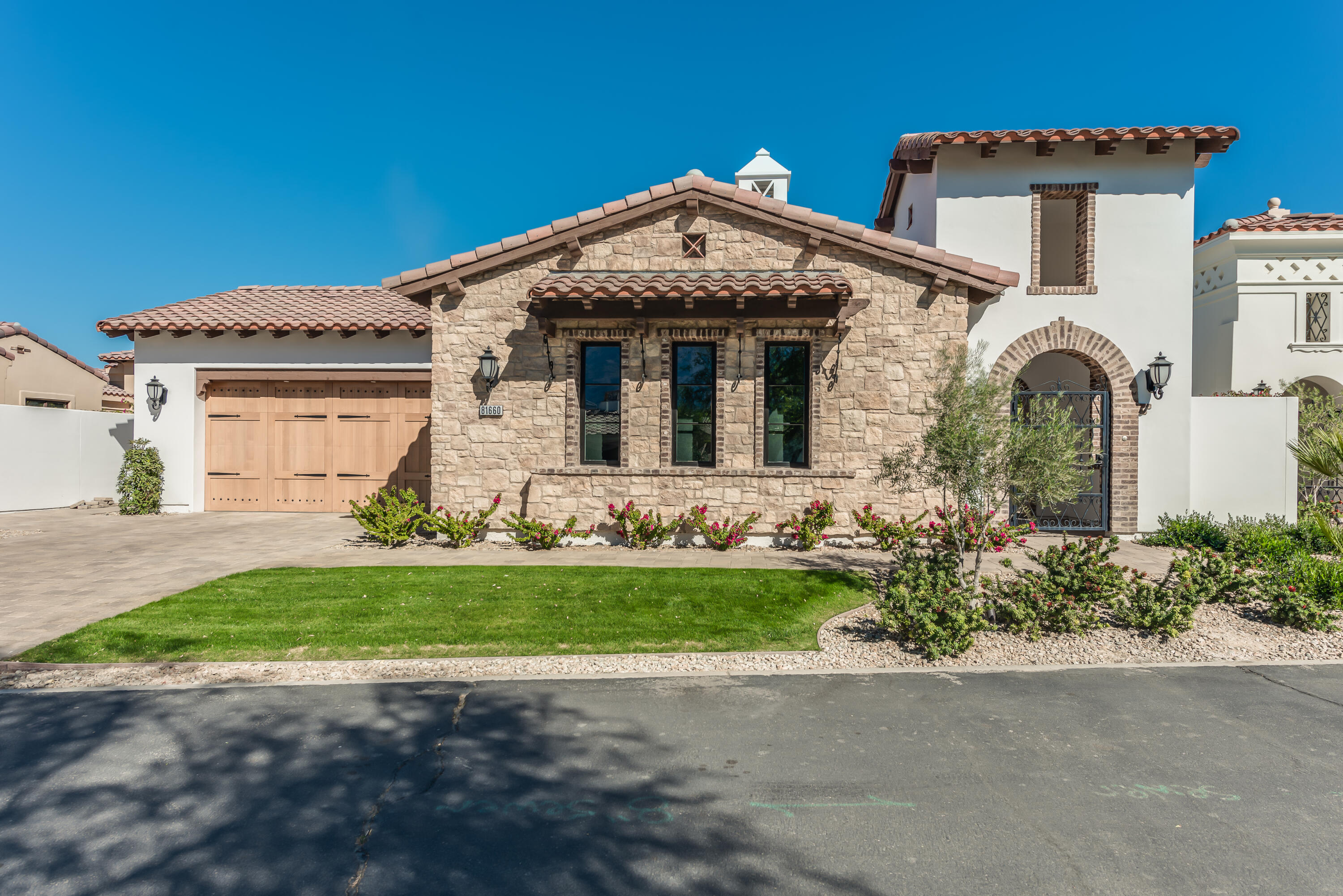 81660 Andalusia La Quinta, CA 92253 - Photo 2 of 36 a front view of a house with a garden