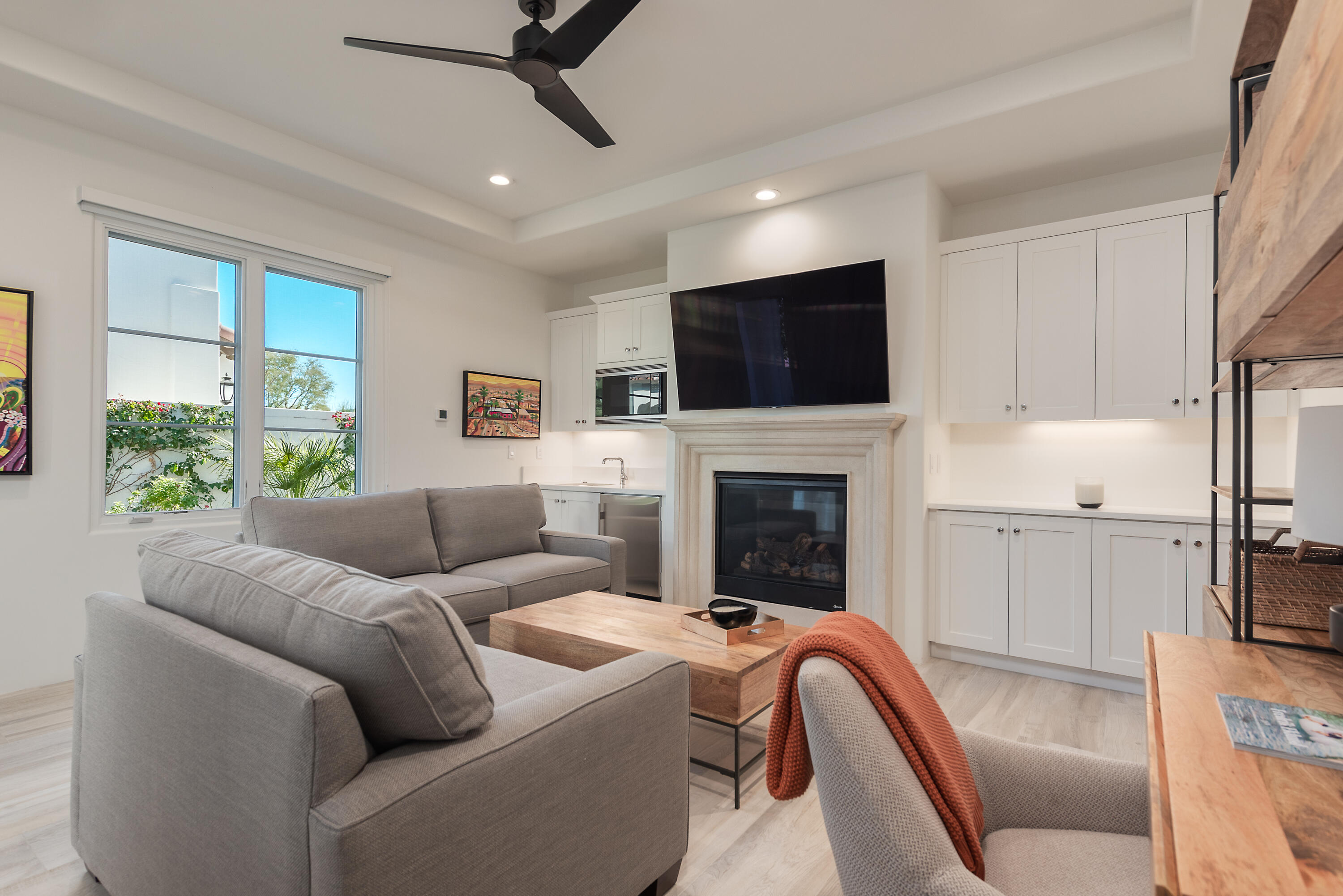 81660 Andalusia La Quinta, CA 92253 - Photo 32 of 36 a living room with furniture a fireplace and a flat screen tv