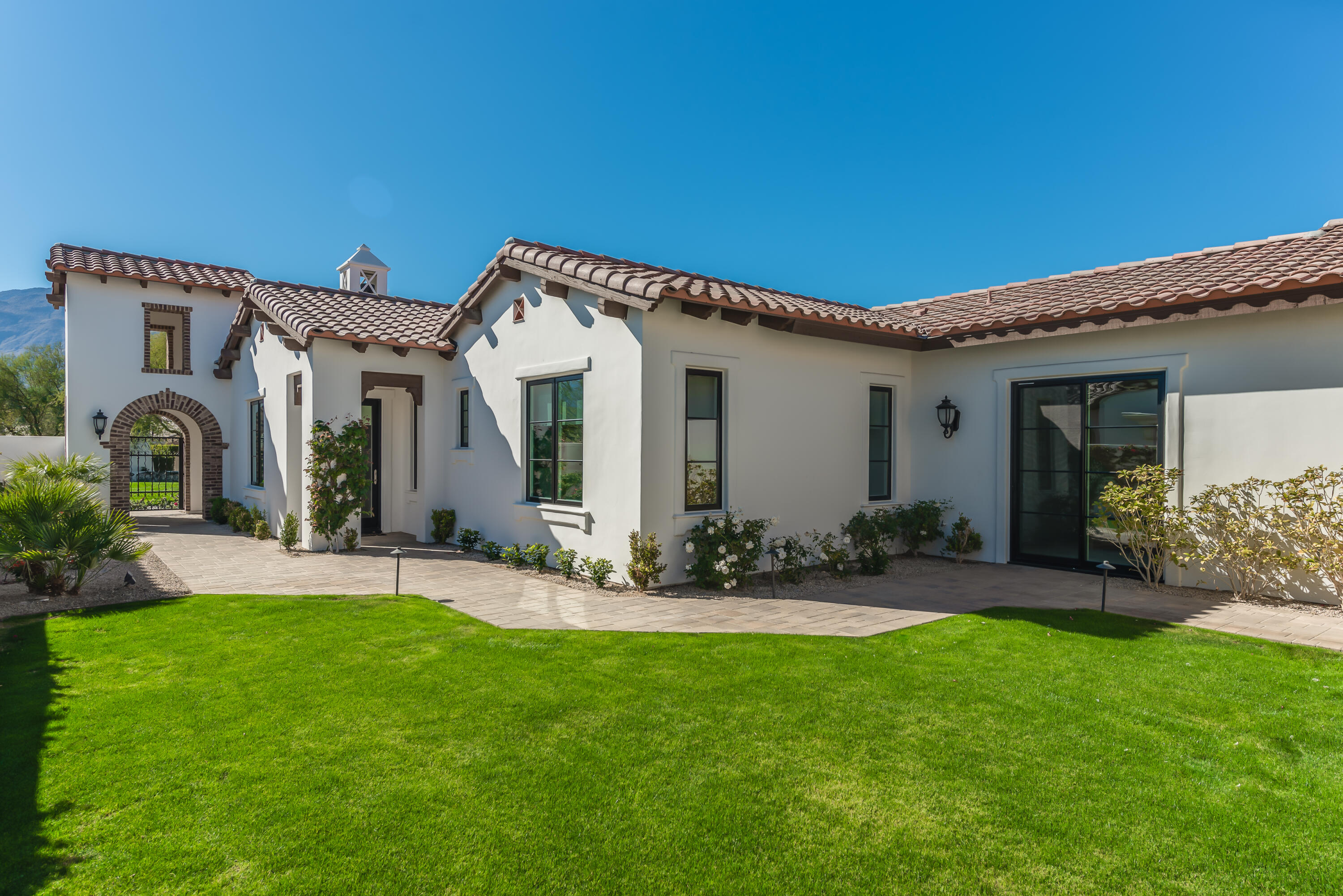 81660 Andalusia La Quinta, CA 92253 - Photo 5 of 36 a front view of a house with a garden and plants