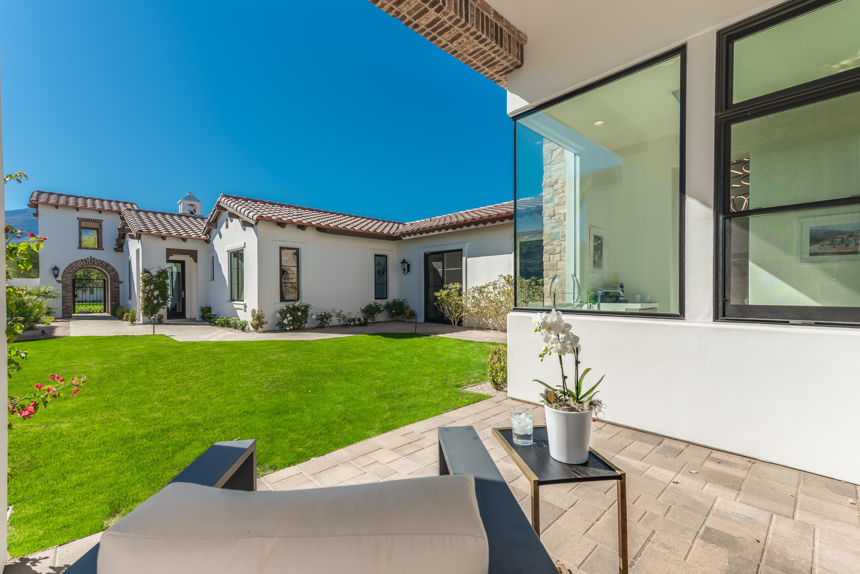 81660 Andalusia La Quinta, CA 92253 - Photo 6 of 36 a view of a white house with a yard