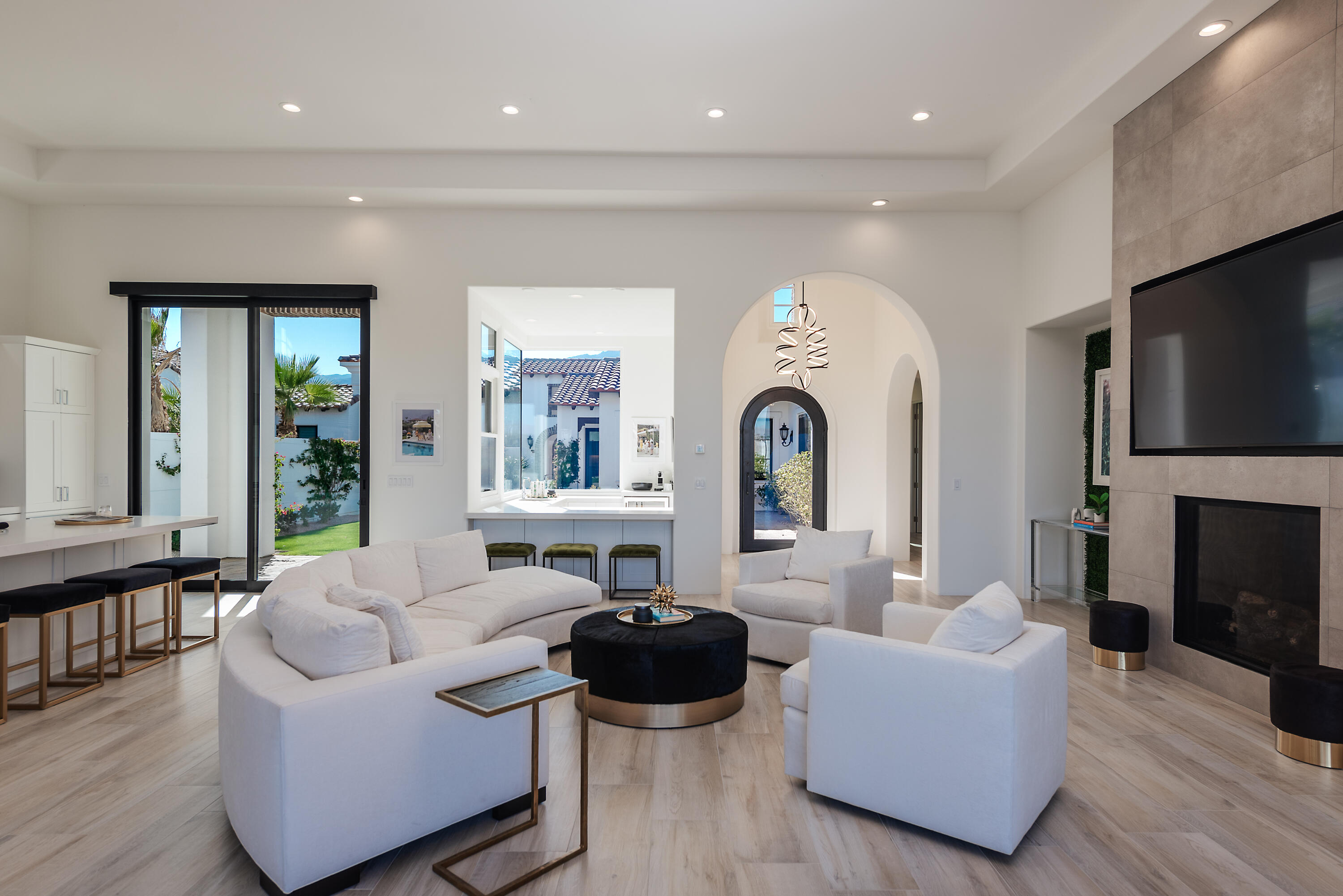 81660 Andalusia La Quinta, CA 92253 - Photo 9 of 36 a living room with fireplace furniture and a large window