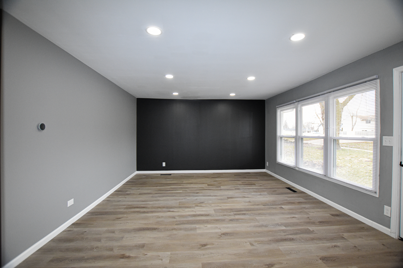 109 South Bartlett Road Streamwood, IL 60107 - Photo 11 of 39 a view of an empty room with wooden floor and a window