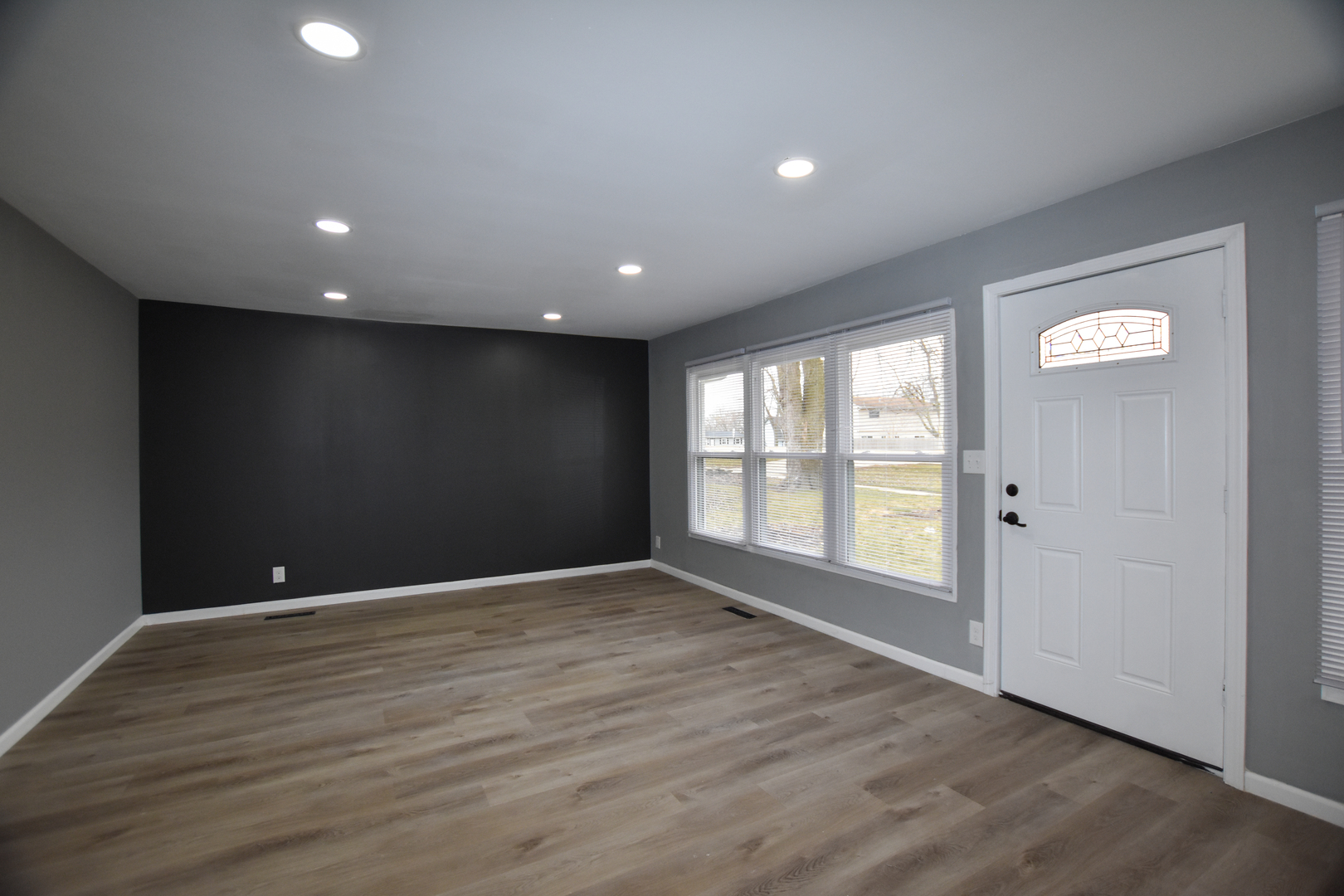 109 South Bartlett Road Streamwood, IL 60107 - Photo 13 of 39 a view of an empty room with wooden floor and a window