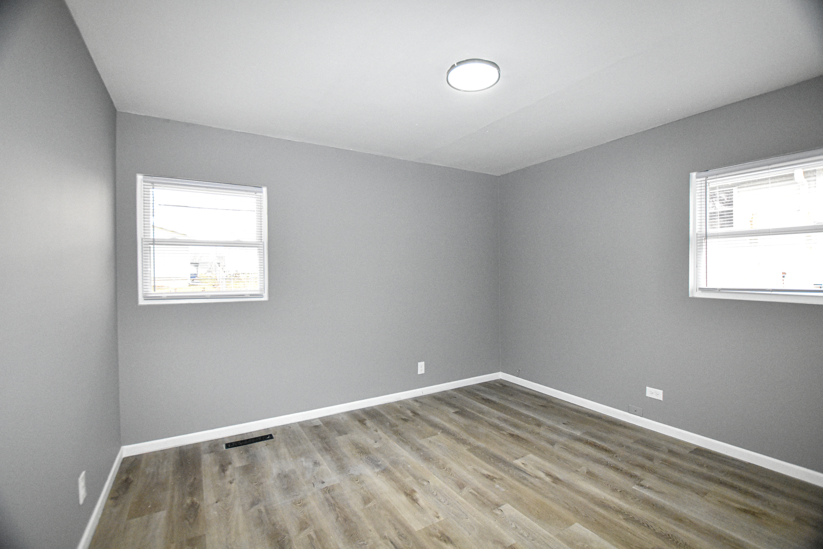 109 South Bartlett Road Streamwood, IL 60107 - Photo 14 of 39 an empty room with wooden floor and windows