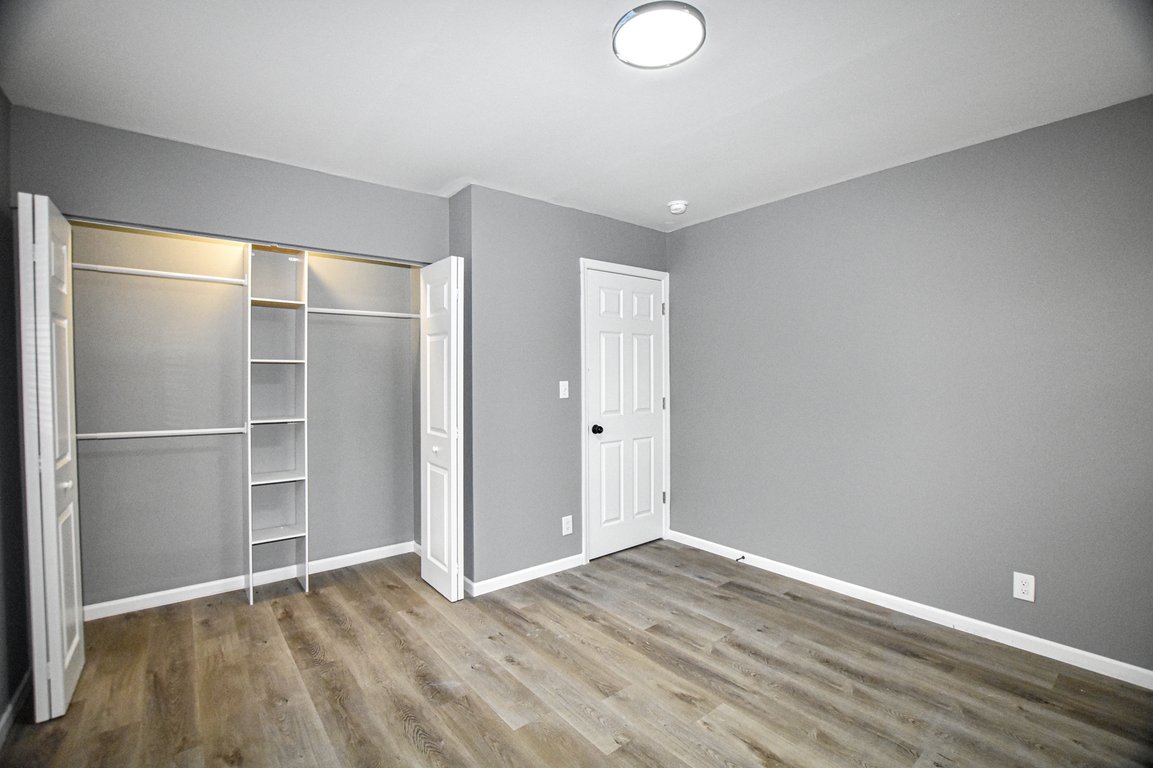 109 South Bartlett Road Streamwood, IL 60107 - Photo 16 of 39 a view of an empty room with wooden floor and closet