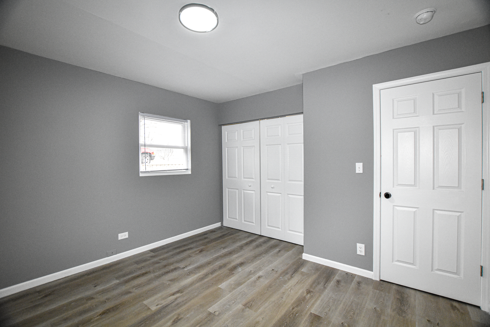 109 South Bartlett Road Streamwood, IL 60107 - Photo 17 of 39 an empty room with wooden floor and windows