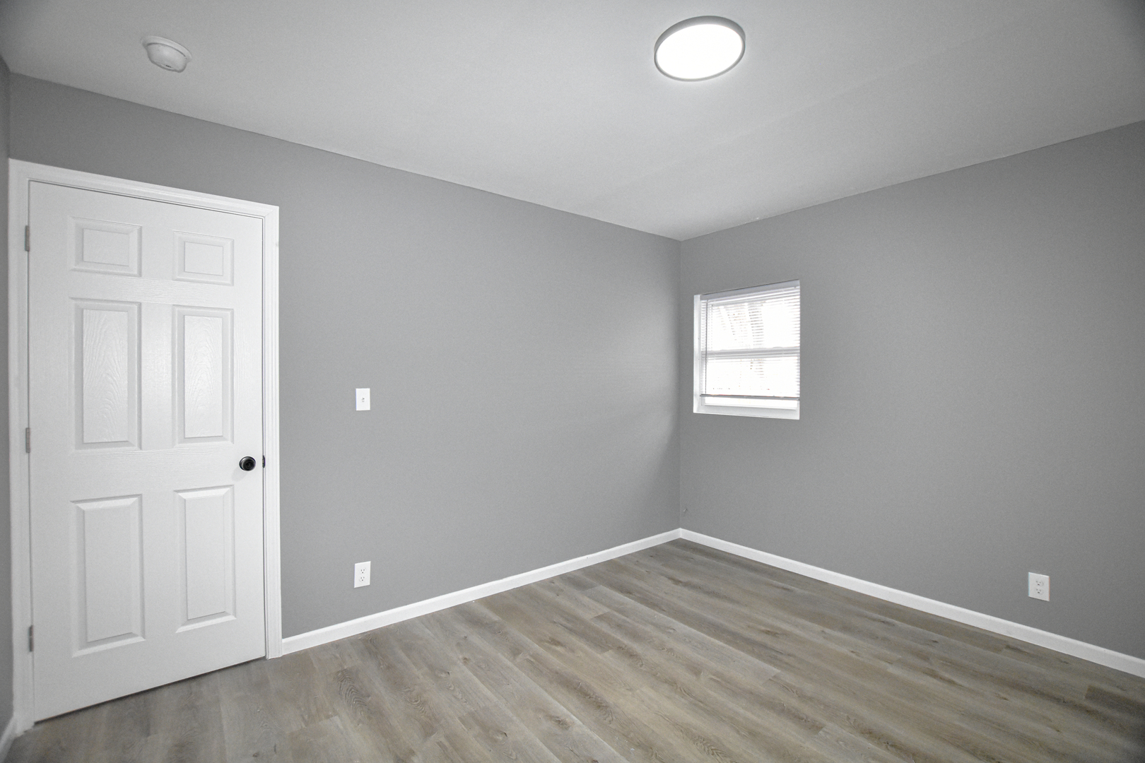 109 South Bartlett Road Streamwood, IL 60107 - Photo 22 of 39 an empty room with wooden floor and windows