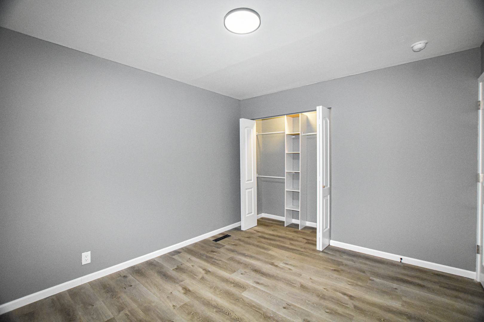 109 South Bartlett Road Streamwood, IL 60107 - Photo 23 of 39 an empty room with wooden floor and windows