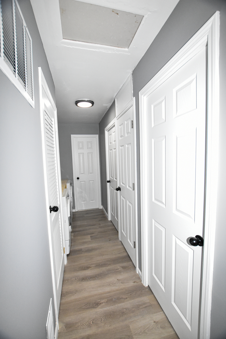 109 South Bartlett Road Streamwood, IL 60107 - Photo 32 of 39 a view of a hallway with wooden floor and entryway