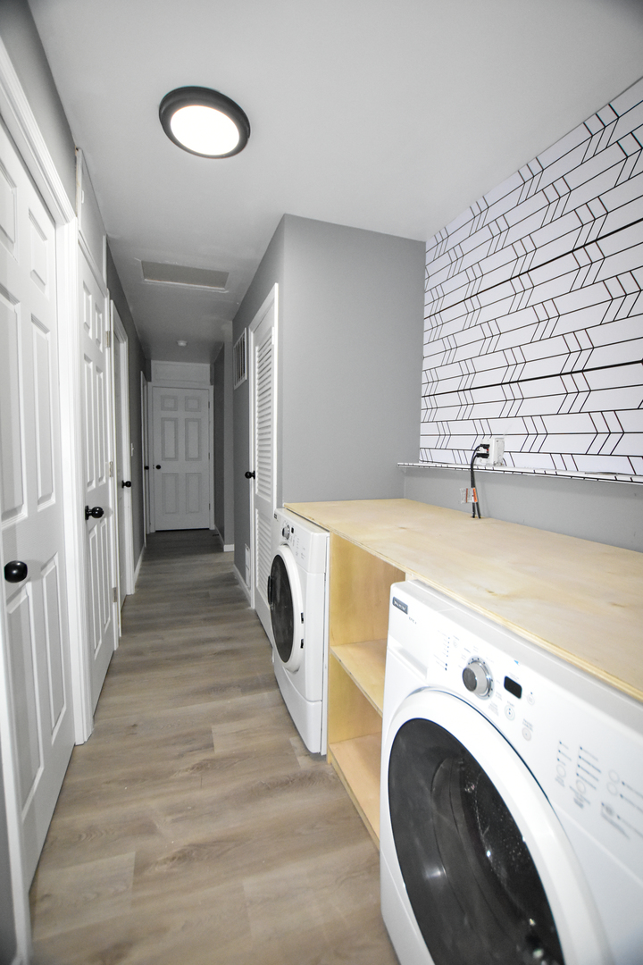 109 South Bartlett Road Streamwood, IL 60107 - Photo 34 of 39 a view of a hallway with washer and dryer