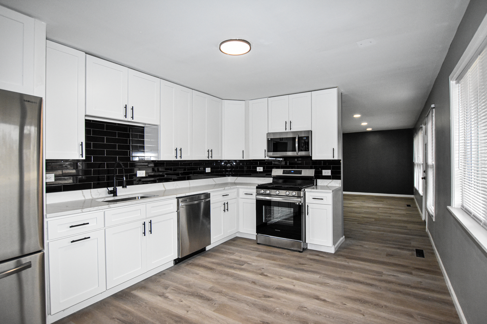 109 South Bartlett Road Streamwood, IL 60107 - Photo 7 of 39 a kitchen with stainless steel appliances granite countertop a stove a sink and a refrigerator