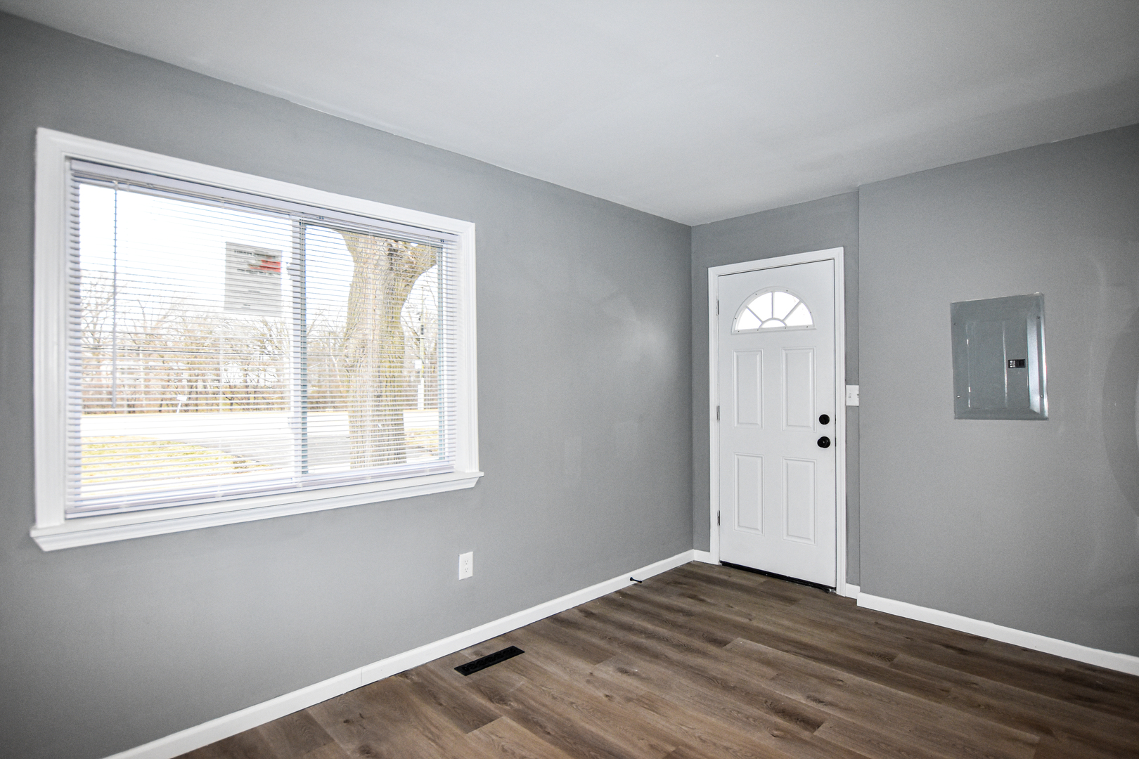 109 South Bartlett Road Streamwood, IL 60107 - Photo 8 of 39 a view of an empty room with wooden floor and a window