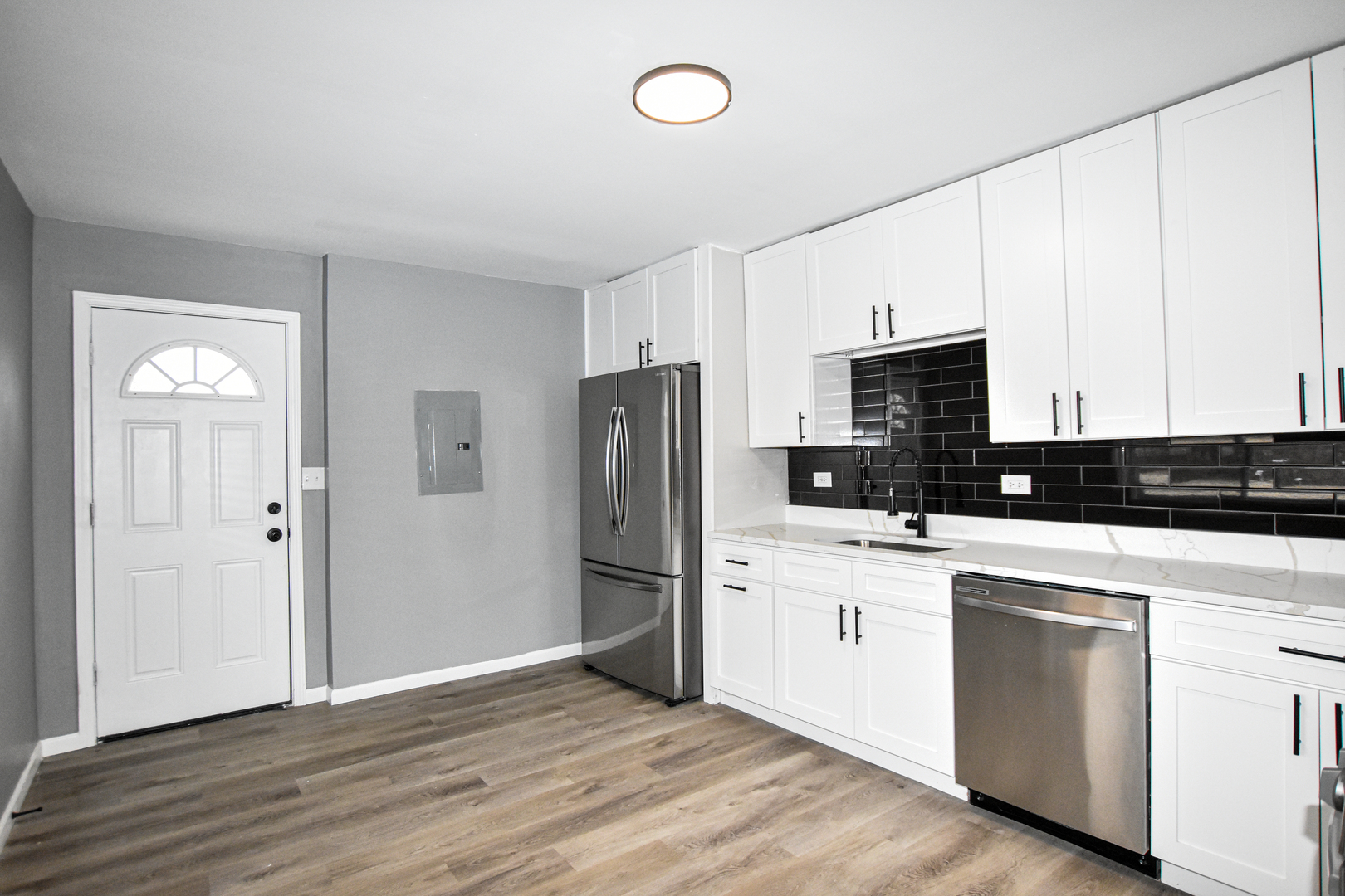 109 South Bartlett Road Streamwood, IL 60107 - Photo 9 of 39 a kitchen with a refrigerator stove and white cabinets